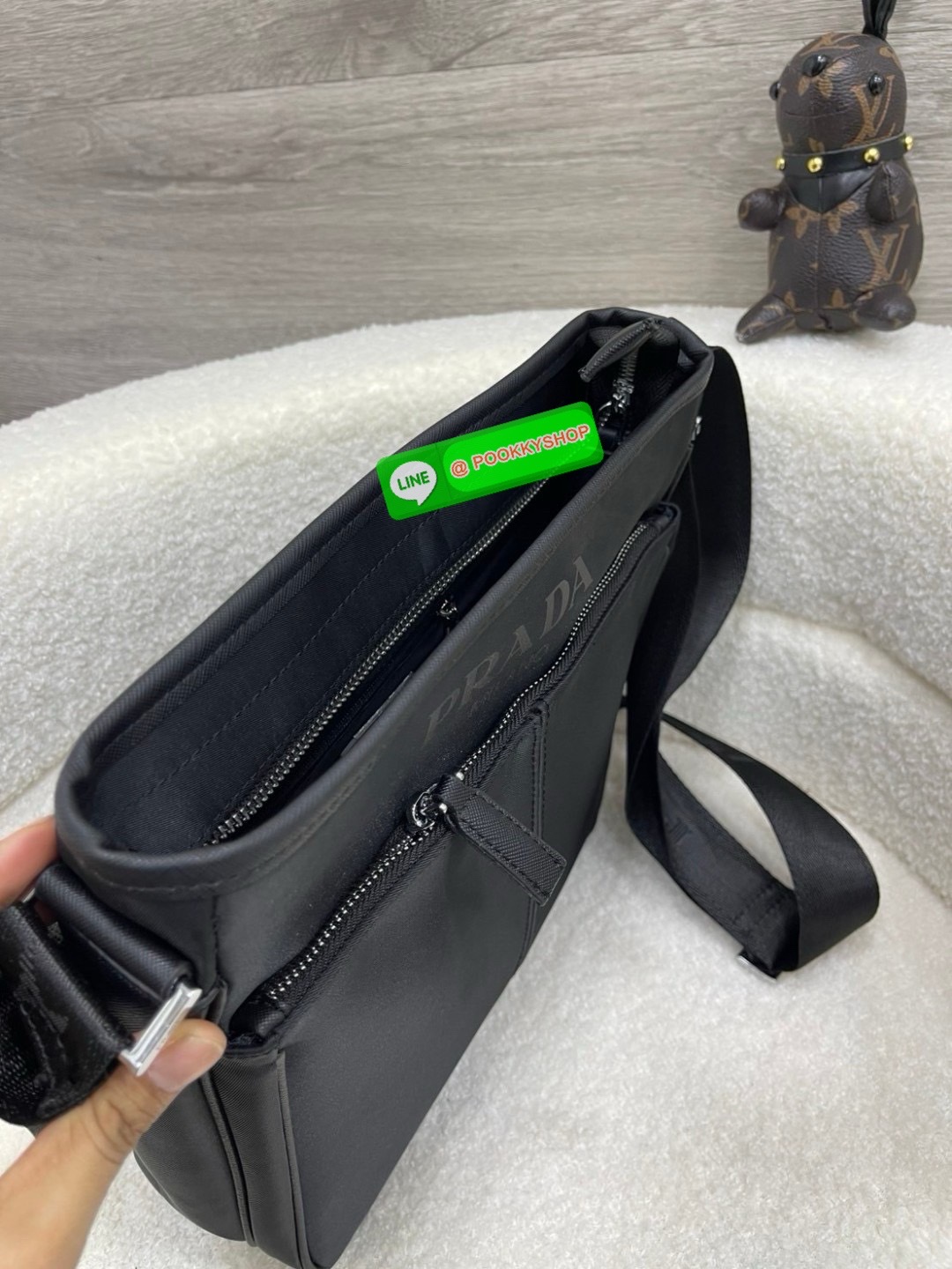 Prada Re-Nylon and Saffiano leather shoulder bag Size 11” Adjustable woven nylon tape and leather shoulder strap with removable pouch Enameled metal triangle logo on the front Zipper closure External zipper pocket Internal patch pocket Re-Nylon logo-print