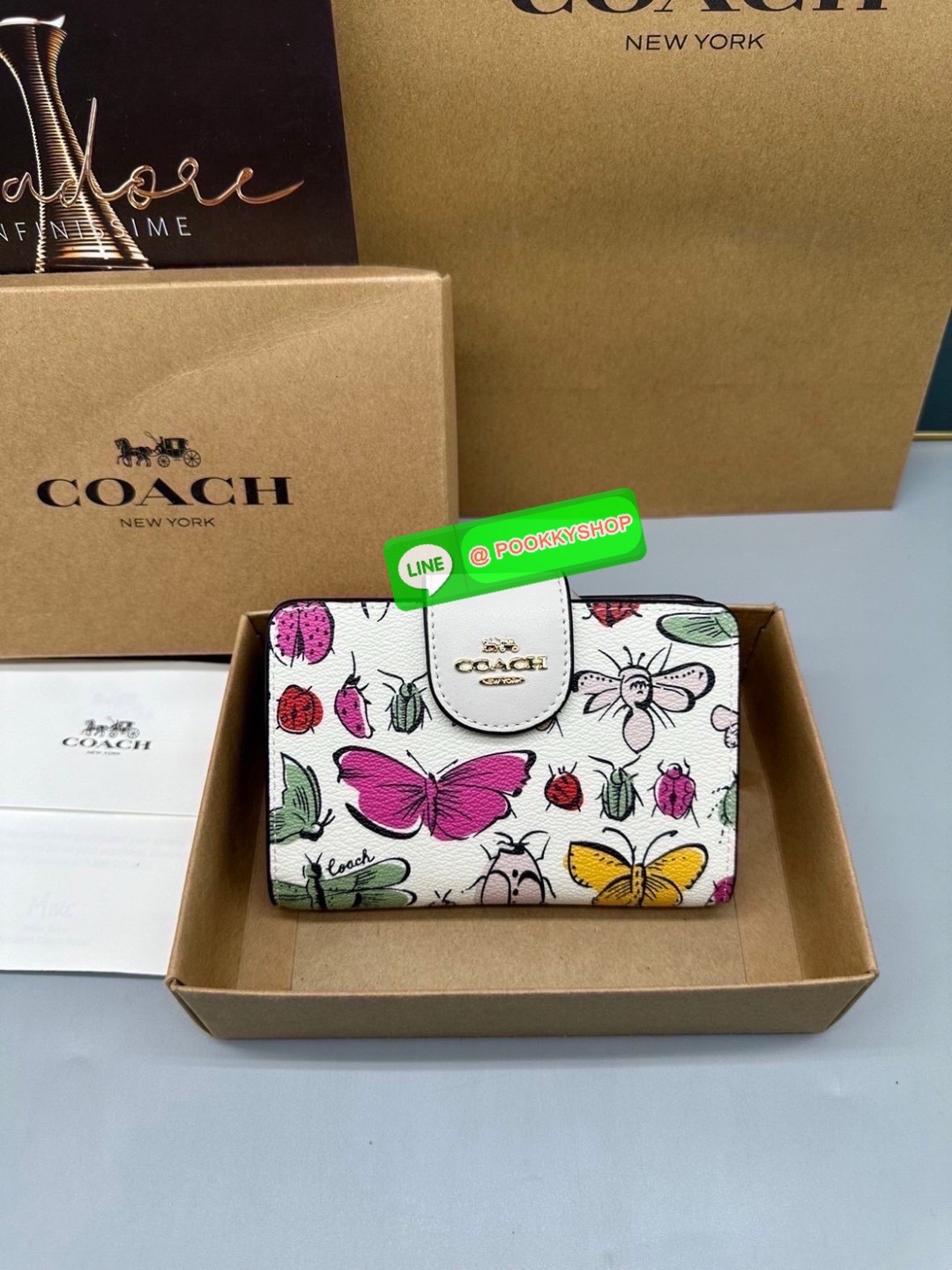 Coach Billfold Wallet With Floral Print Polished pebble leather Eight credit card slots Full-length bill compartment Snap closure Outside zip coin pocket