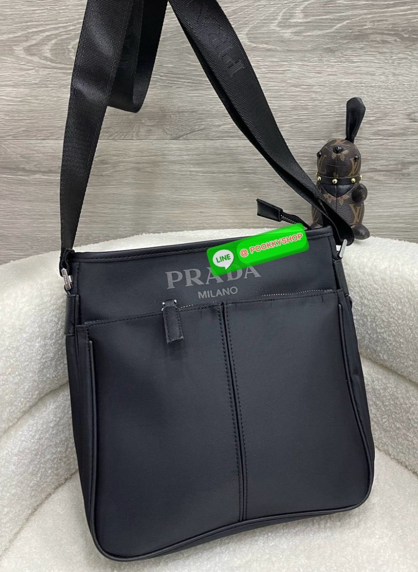 Prada Re-Nylon and Saffiano leather shoulder bag Size 11” Adjustable woven nylon tape and leather shoulder strap with removable pouch Enameled metal triangle logo on the front Zipper closure External zipper pocket Internal patch pocket Re-Nylon logo-print