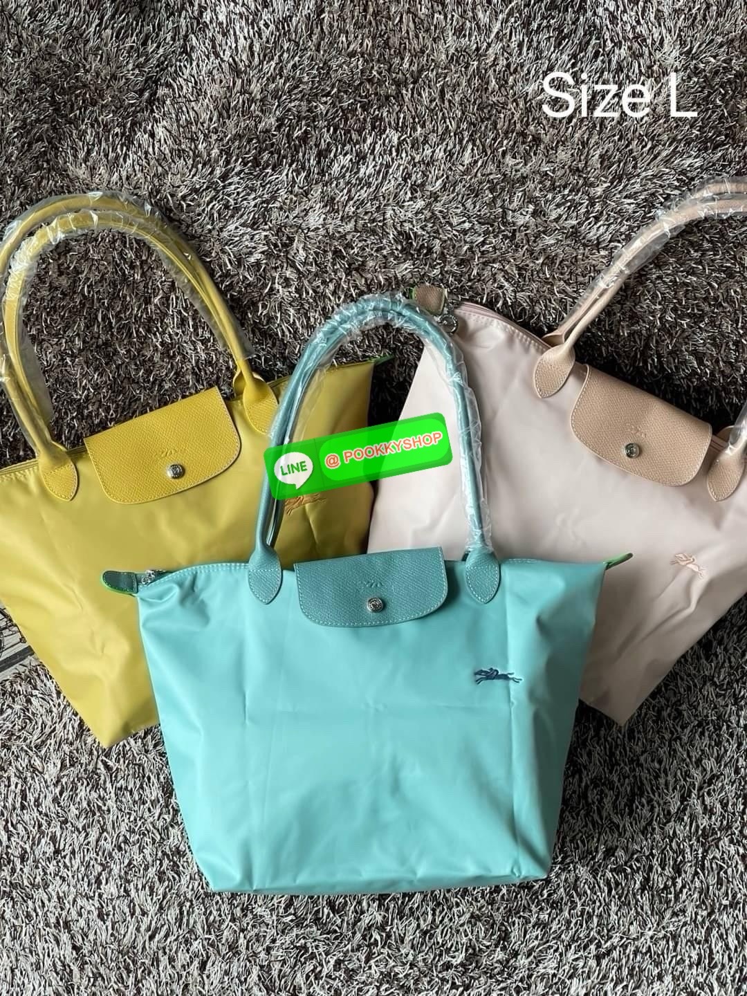 LONGCHAMP LE PLIAGE GREEN Shoulder bag L กระเป๋าโท้ทใบนี้ดึงดูดใจคุณด้วยรูปทรงมินิมอลและปริมาตรที่เพียงพอซึ่งสามารถเก็บเอกสารหรือแล็ปท็อปทั้งหมดของคุณได้อย่างง่ายดาย ด้ามยาวช่วยให้คุณสวมใส่ได้อย่างสบายบนไหล่ ขณะที่การปิดด้วยซิปช่วยให้มั่นใจได้ว่าสิ่งของทั