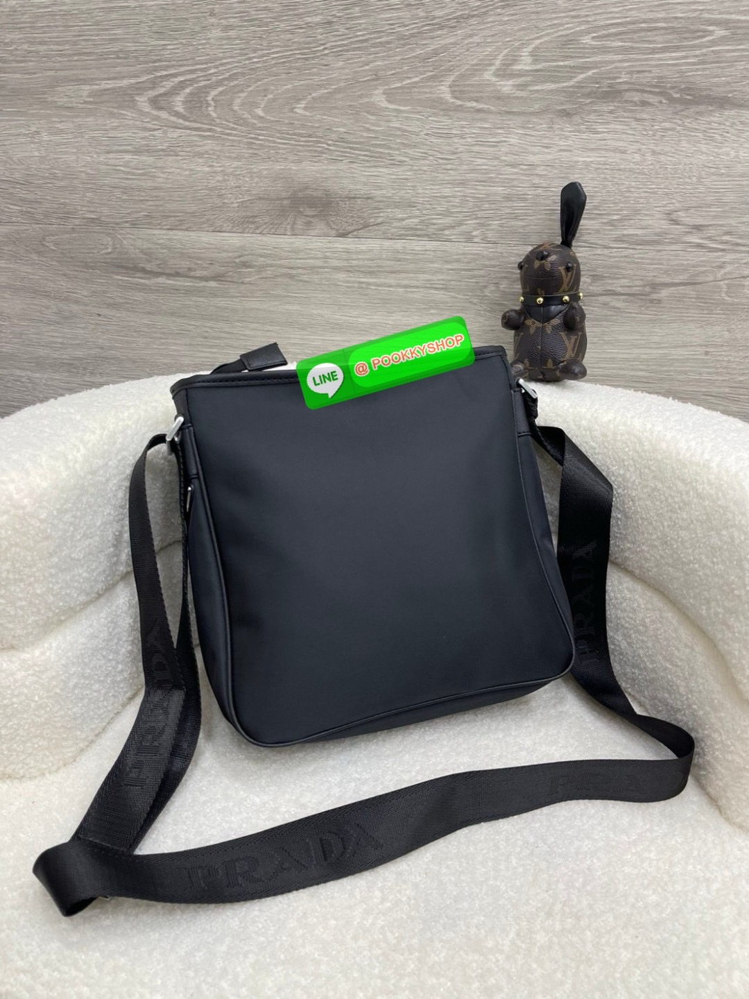 Prada Re-Nylon and Saffiano leather shoulder bag Size 11” Adjustable woven nylon tape and leather shoulder strap with removable pouch Enameled metal triangle logo on the front Zipper closure External zipper pocket Internal patch pocket Re-Nylon logo-print