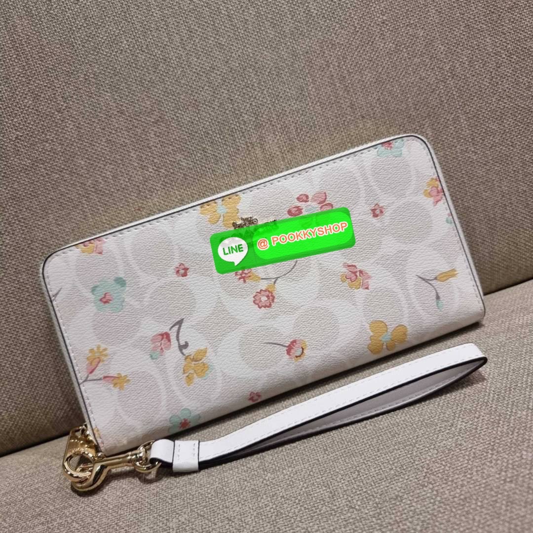 COACH C8695 LONG ZIP AROUND WALLET IN SIGNATURE CANVAS WITH MYSTICAL FLORAL PRINT พร้อมเสิร์ฟความหรู กับคอลใหม่ล่าสุด กระเป๋าสตางค์ใบยาวกึ่งคล้องมือ มาในดีไซน์ผู้ดี เรียบหรู ถือใช้แล้วขับผิวมาก ลวดลายดอกไม้คละเคล้าสวยงาม วัสดุหนังแคนวาสเคลือบลาย มาพร้อมสา