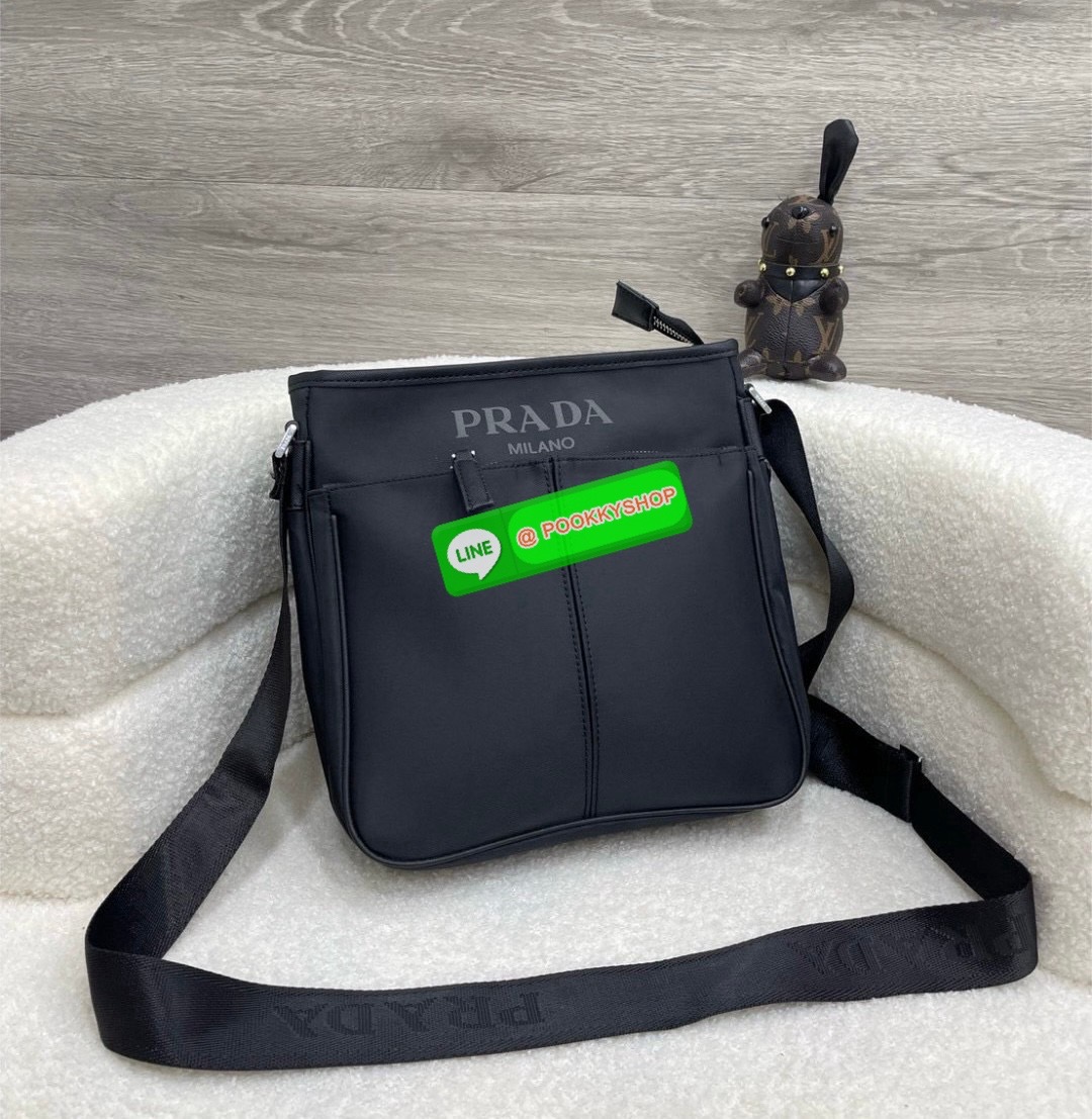Prada Re-Nylon and Saffiano leather shoulder bag Size 11” Adjustable woven nylon tape and leather shoulder strap with removable pouch Enameled metal triangle logo on the front Zipper closure External zipper pocket Internal patch pocket Re-Nylon logo-print