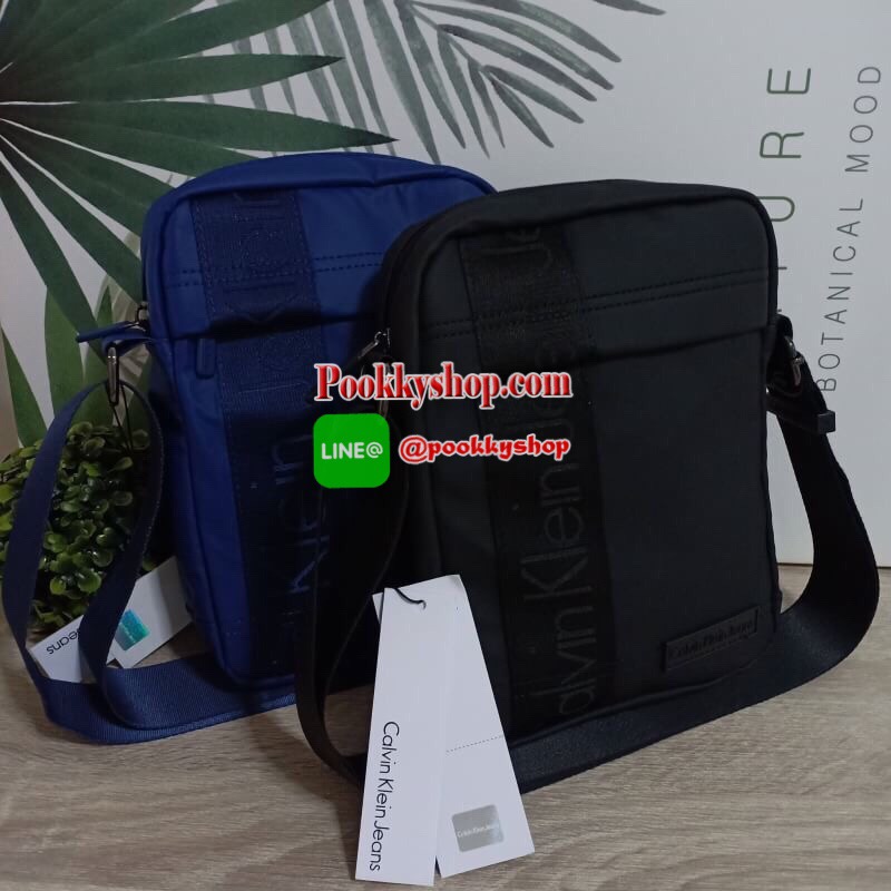Calvin Klein Jeans กระเป๋าสะพายหนังเรียบด้าน หนังกันน้ำ สะพายได้สองแบบ crossbody และสามารถปรับเป็นสายคู่สะพายข้างได้ ขนาดกำลังดีไม่เล็กไม่ใหญ่จนเกินไป พกพาสะดวก ด้านหน้าประดับด้วยป้ายโลโก้แบรนด์ มีช่องซิป1ช่อง กระเป๋าเปิดปิดด้วยซิปบน หัวซิปโลโก้แบรนด์ ภาย