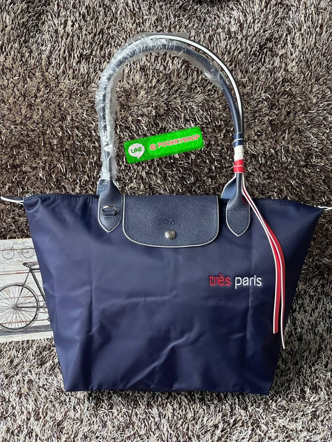 💕LONGCHAMP LE PLIAGE TRES PARIS SHOULDER BAG กระเป๋าโท้ทใบนี้ดึงดูดใจคุณด้วยรูปทรงมินิมอลและปริมาตรที่เพียงพอซึ่งสามารถเก็บเอกสารหรือแล็ปท็อปทั้งหมดของคุณได้อย่างง่ายดาย สายคล้องไหล่มีความยาวช่วยให้คุณสะพายได้อย่างสบาย ขณะที่การปิดด้วยซิปช่วยให้มั