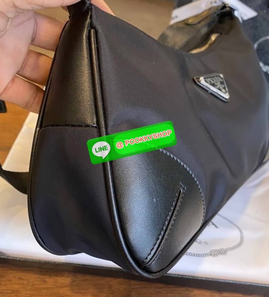 prada nylon shoulder bag black This chic shoulder bag is crafted of fine tessuto nylon in black. This bag features sturdy calfskin leather top handle and silver hardware. The top zipper opens with a black jacquared fabric interior with zipper pocket. This