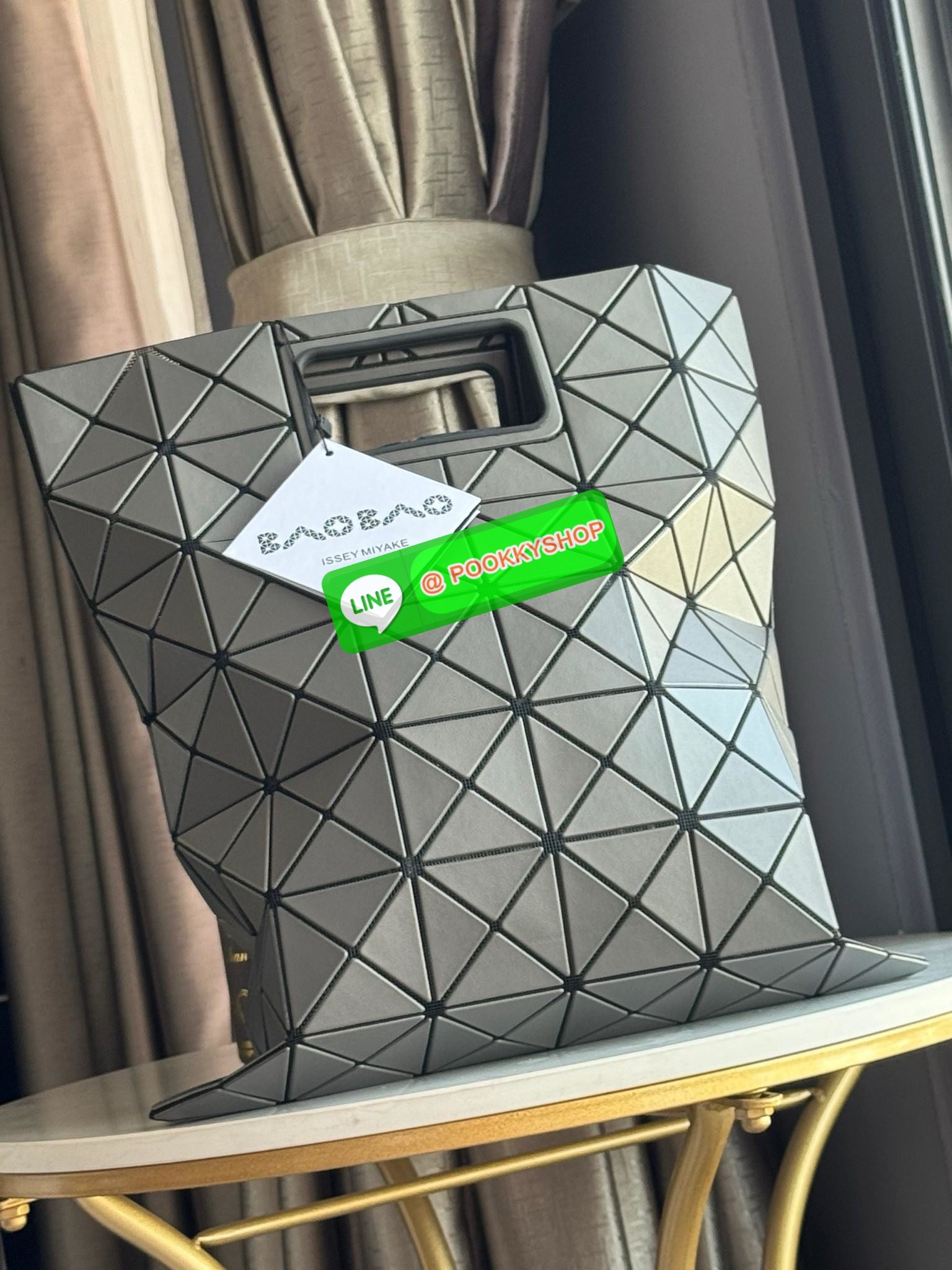 Baobao Issey Miyake large Bocca matte-finish tote bag BOCCA MATTE เป็นกระเป๋าถือรูปแบบใหม่ที่มีด้ามจับด้านในที่ช่วยให้กระเป๋าวางอยู่บนแขนหรือข้อมือได้อย่างนุ่มนวล เป็นกระเป๋าถือขนาดใหญ่นี้มีกระเป๋าด้านในพร้อมซิปที่ช่วยให้จัดเก็บได้อย่างปลอดภัย สามารถใส่แล