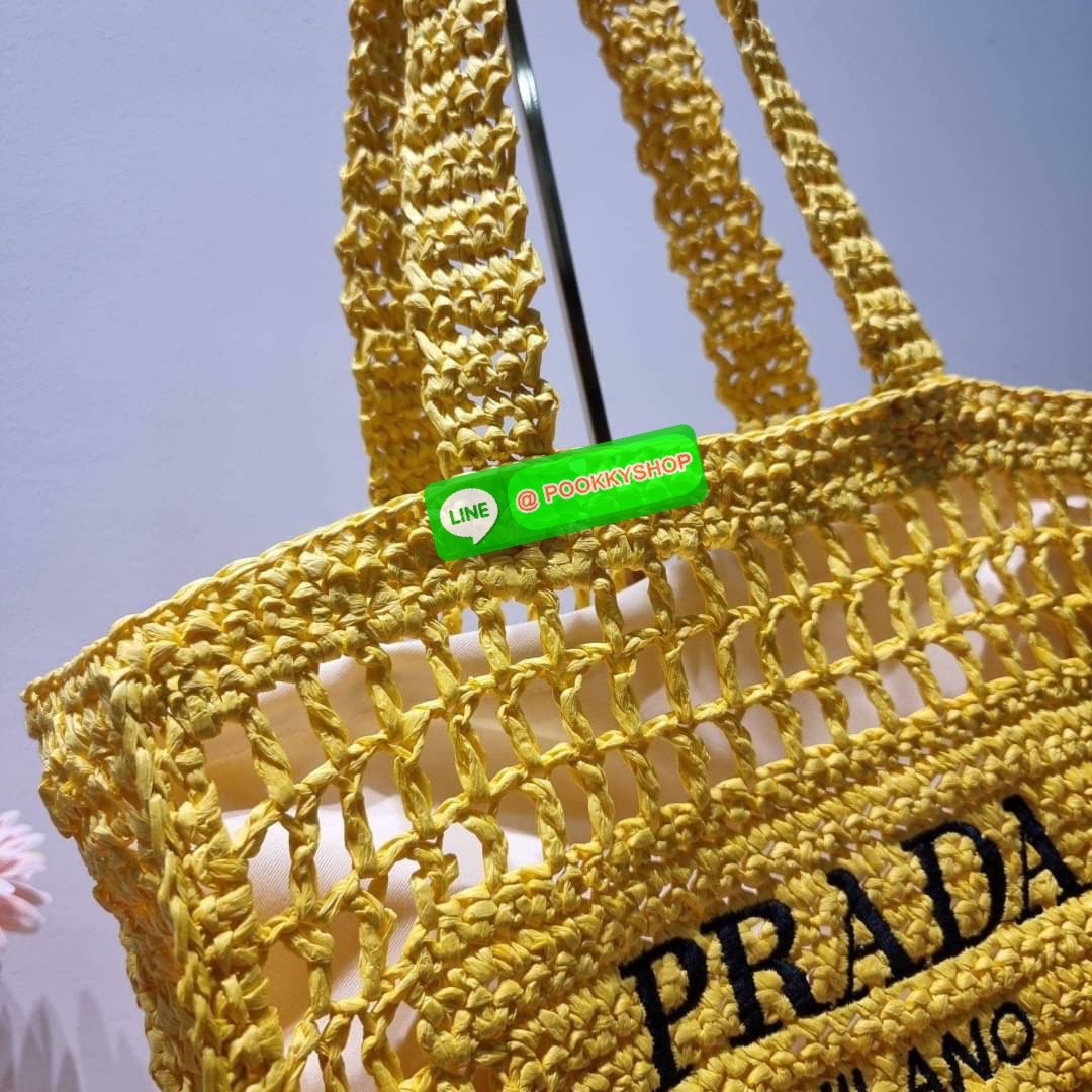 PRADA RAFFIA TOTE BAG สวยไม่ซ้ำใคร สไตล์บีช เหมาะมากกับการสะพายไปเที่ยวทะเล หรือจะใช้ในวันสบายๆก็ตอบโจทย์ กับกระเป๋าสะพายสานใบใหญ่ ตัวกระเป๋าเป็นวัสดุสังเคราห์จากธรรมชาติ สานทอเต็มใบออกมาเป็นลวดลายสวยงาม มีกระเป๋าซับในให้ สำหรับใส่ของเป็นสัดส่วน และรูดปาก