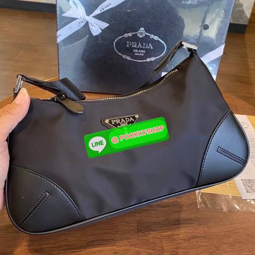 prada nylon shoulder bag black This chic shoulder bag is crafted of fine tessuto nylon in black. This bag features sturdy calfskin leather top handle and silver hardware. The top zipper opens with a black jacquared fabric interior with zipper pocket. This