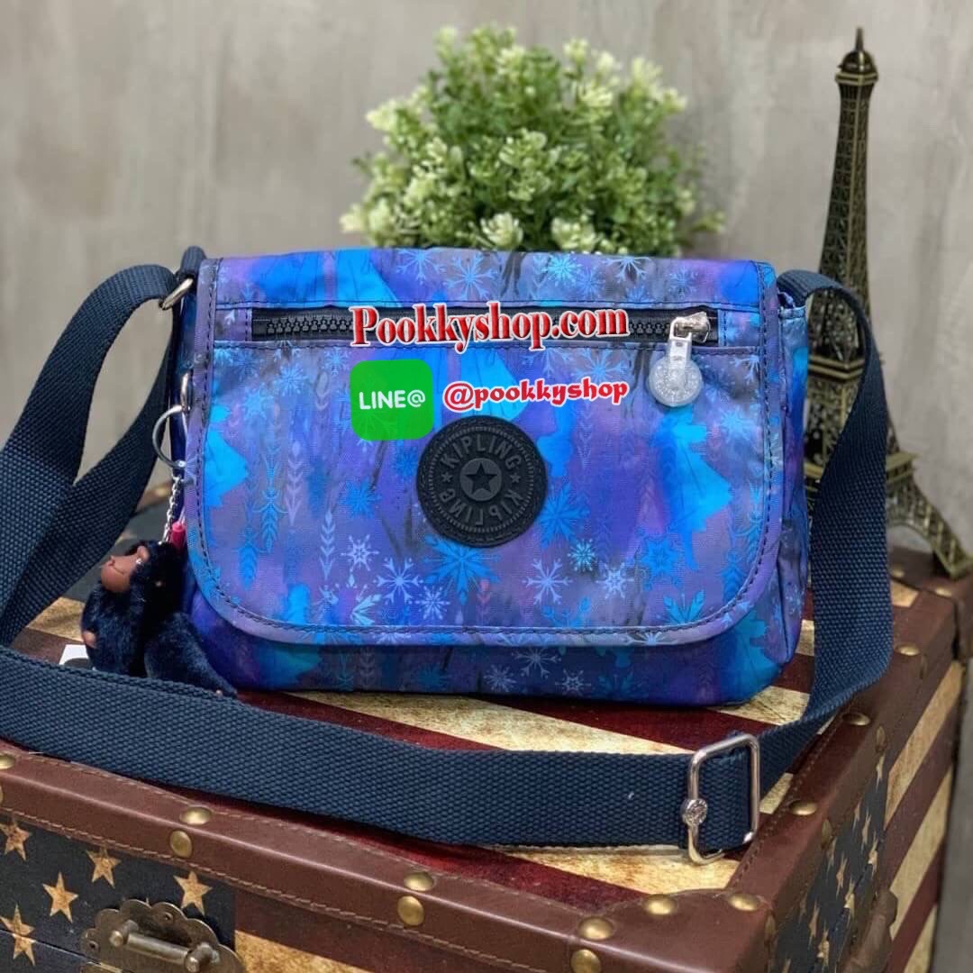Kipling Sabian Shoulder Bag จาก Disney Frozen Series Collection วัสดุ Polyester ทรงครอสบอดี้ สไตล์สุดฮิตกับการใช้งานที่ง่าย หยิบจับของได้อย่างสะดวกสบาย เปิดปิดด้วยกระดุมแม่เหล็กและซิปด้านใน เพิ่อความปลอดภัย ลายผ้าบุด้านในดูมีดีเทล สายสะพายปรับได้ฟรีไซส์ ป