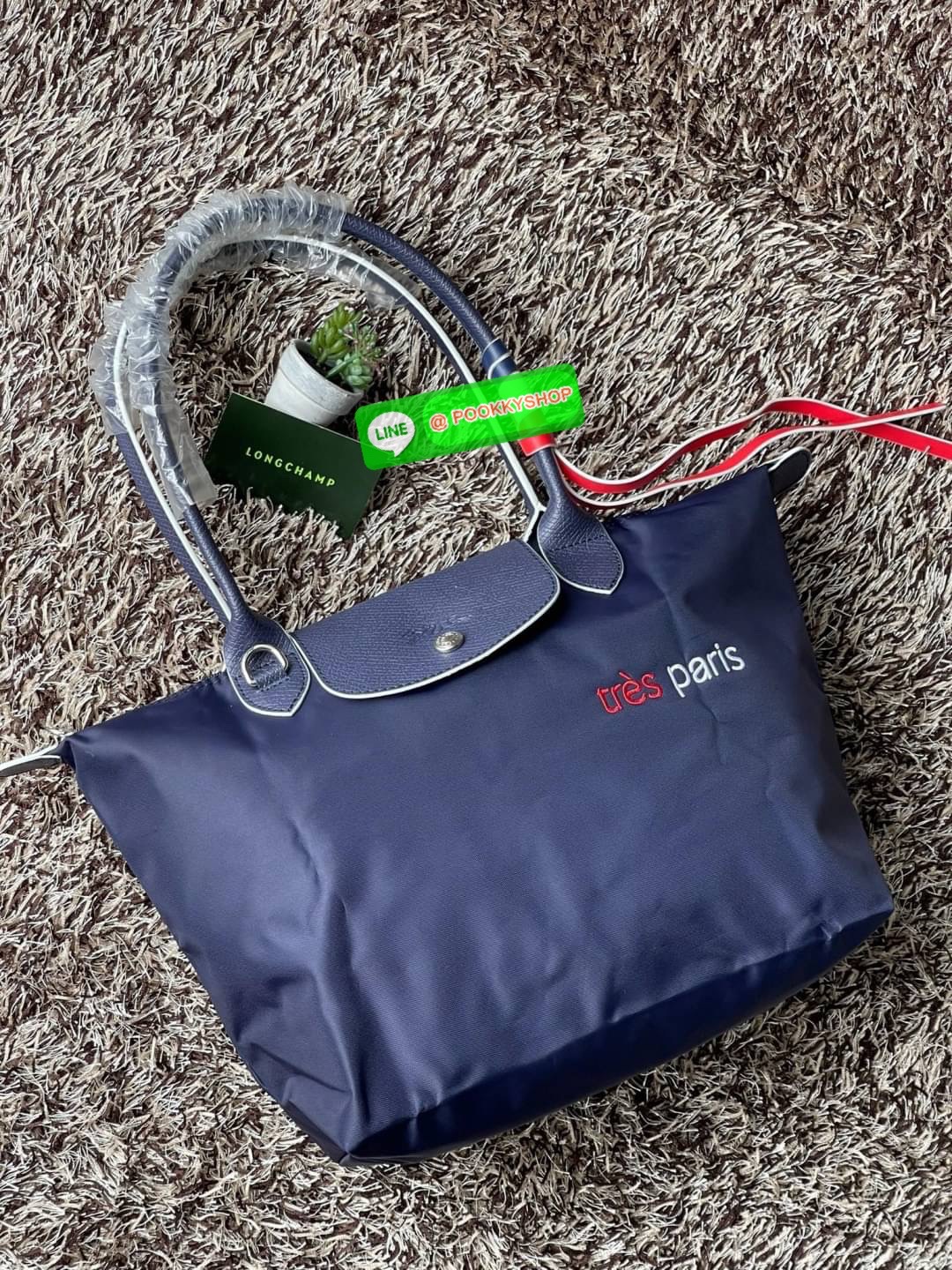 💕LONGCHAMP LE PLIAGE TRES PARIS SHOULDER BAG กระเป๋าโท้ทใบนี้ดึงดูดใจคุณด้วยรูปทรงมินิมอลและปริมาตรที่เพียงพอซึ่งสามารถเก็บเอกสารหรือแล็ปท็อปทั้งหมดของคุณได้อย่างง่ายดาย สายคล้องไหล่มีความยาวช่วยให้คุณสะพายได้อย่างสบาย ขณะที่การปิดด้วยซิปช่วยให้มั