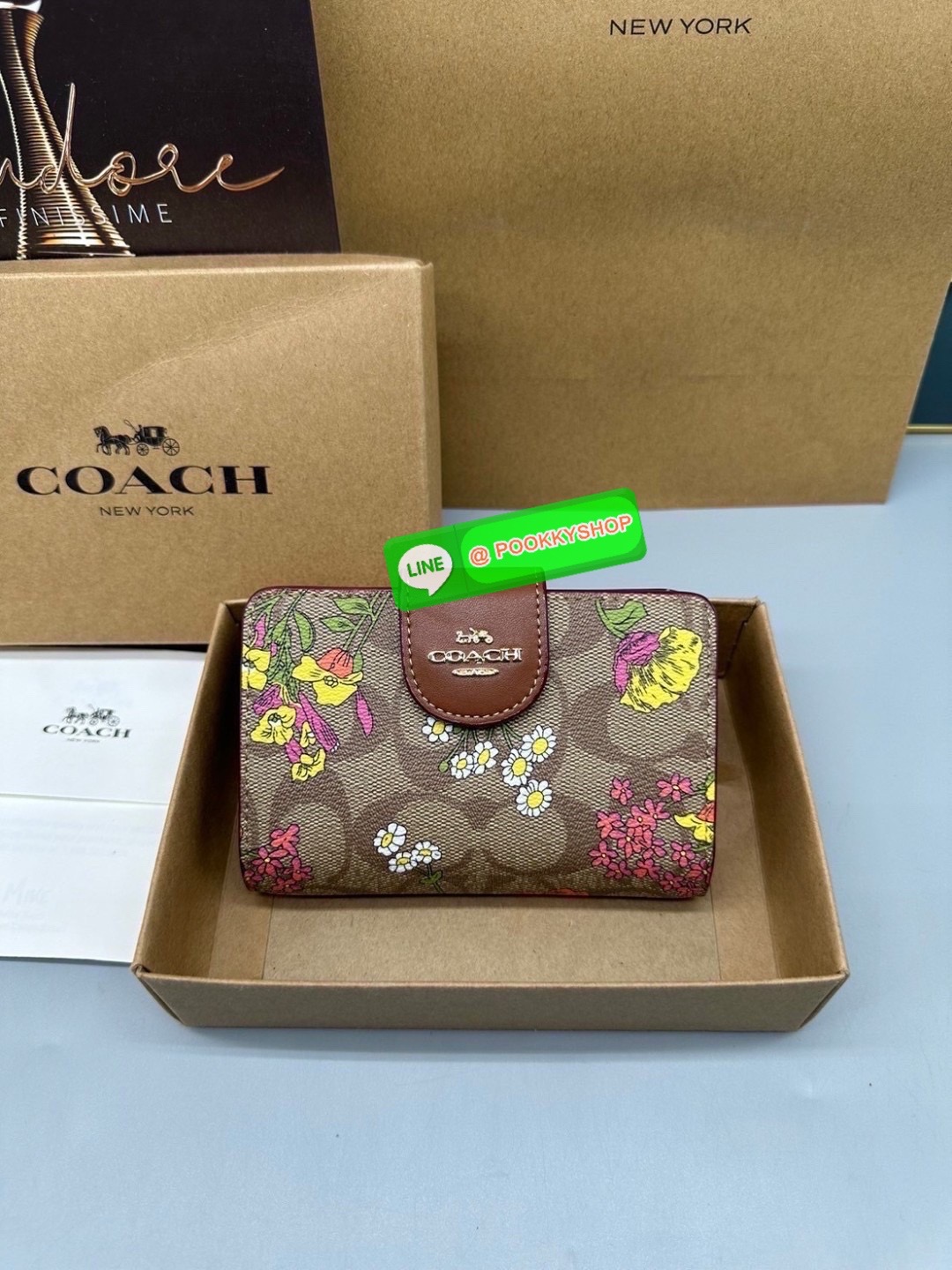 Coach Billfold Wallet With Floral Print Polished pebble leather Eight credit card slots Full-length bill compartment Snap closure Outside zip coin pocket