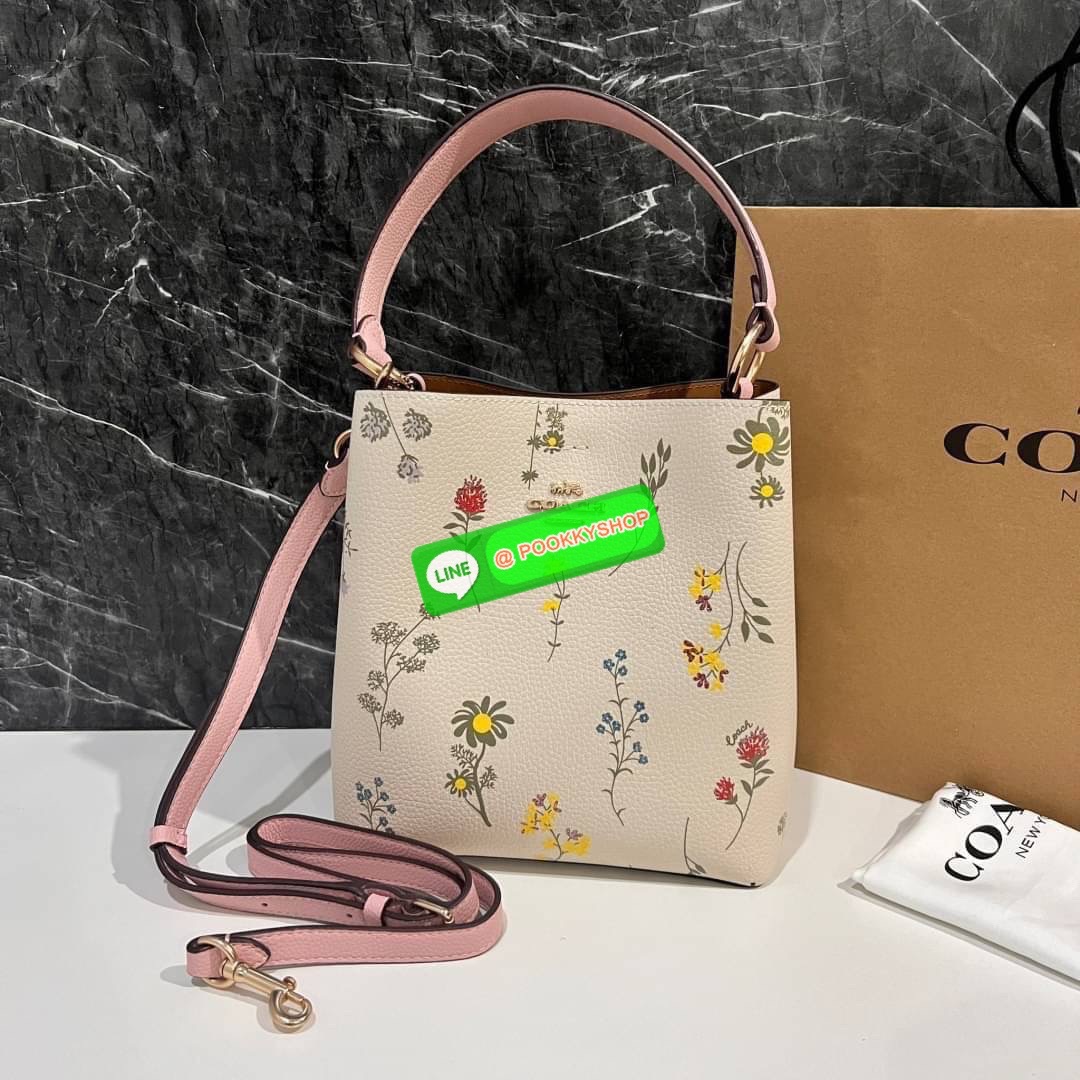 COACH C3598 SMALL TOWN BUCKET WITH SPACED WILDFLOWER PRINT มีความน่ารักละมุนมาก กระเป๋าทรงบัคเก็ต ดีไซน์ดอกไม้คละรอบใบ วัสดุหนังแท้ปากกระเป๋าเปิด-ปิดด้วยกระดุมแม่เหล็ก 2 มีหูจับในตัวและสายสะพายข้าง ภายในโล่งกว้าง มีช่องซิปแยกสัดส่วนตรงกลาง สายสะพายปรับระด