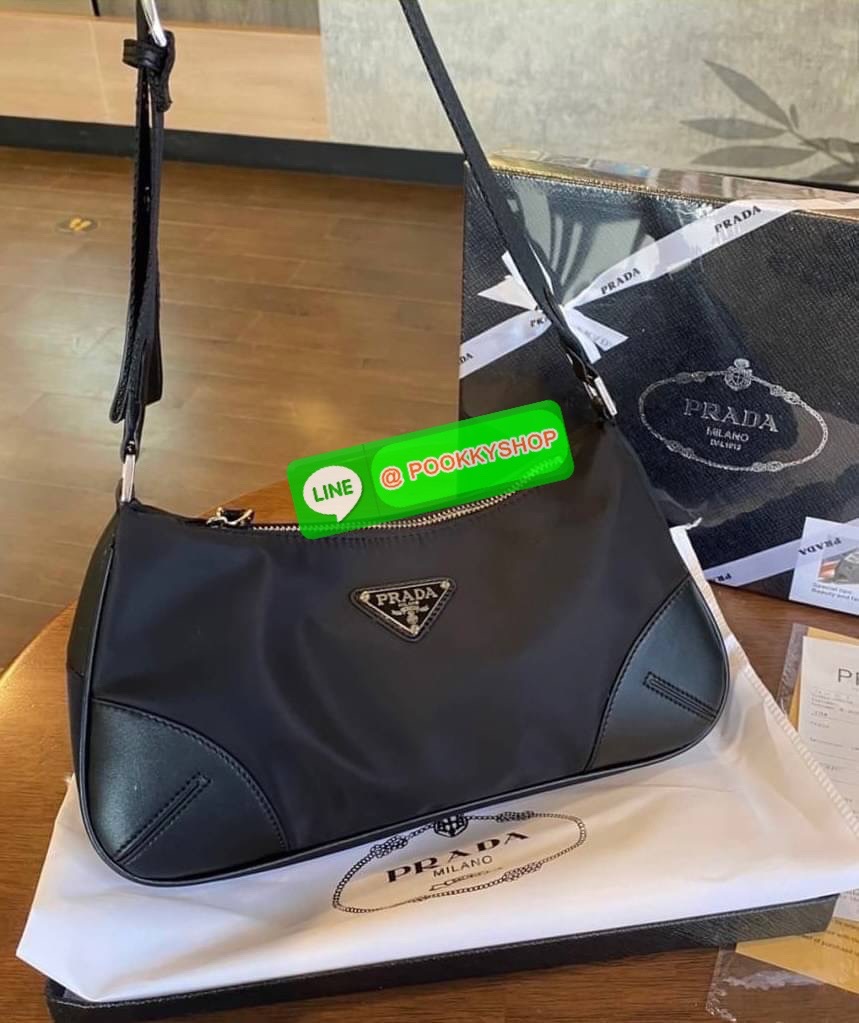 prada nylon shoulder bag black This chic shoulder bag is crafted of fine tessuto nylon in black. This bag features sturdy calfskin leather top handle and silver hardware. The top zipper opens with a black jacquared fabric interior with zipper pocket. This