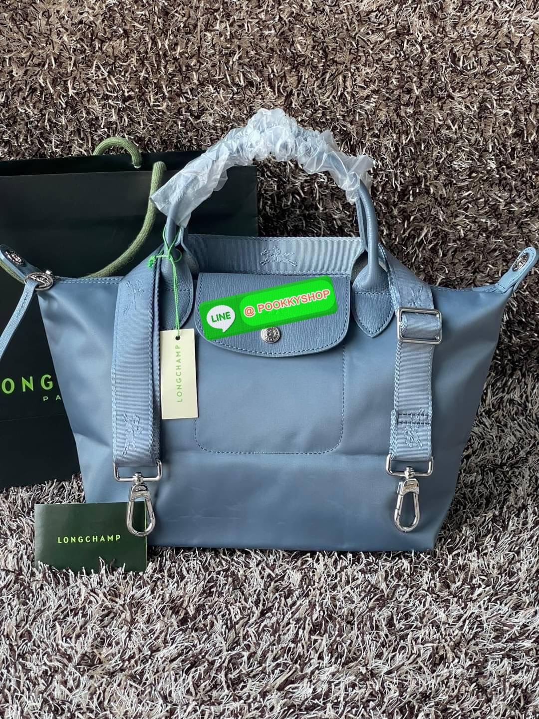 💕Longchamp LE PLIAGE NÉO TOP HANDLE BAG (small size) อีกหนึ่งรุ่นยอดนิยม ที่สาวๆ ต้องมีไว้เก็บไว้สักใบ กระเป๋าโท้ทใบนี้ มาพร้อมกับสีที่มีสไตล์เรียบง่าย มีสายสะพายยาวปรับสั้นยาวได้ช่วยให้คุณสามารถสะพายไหล่ได้อย่างสบาย ในตัวสายปักโลโก้อันเป็นสัญลักษ