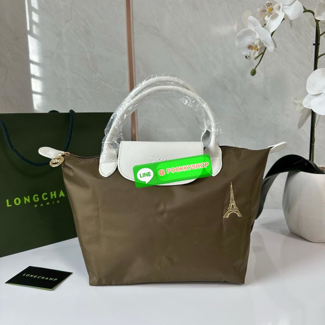 Longchamp Le Pliage Eiffel Tower Tote Bag S 🔖 Collection ใหม่ล่าสุดโดดเด่นด้วยลายปักหอไอเฟลขนาดกระทัดรัดจุของได้เยอะ 🔖วัสดุ : ไนลอนกันน้ำ 🔖เปิด-ปิด ด้วยฝาปิดกระดุมแป๊กมีซิปปิดด้านบน ภายในช่องโล่งกว้างสามารถใส่ iPad ได้ มีช่องแยกด้า