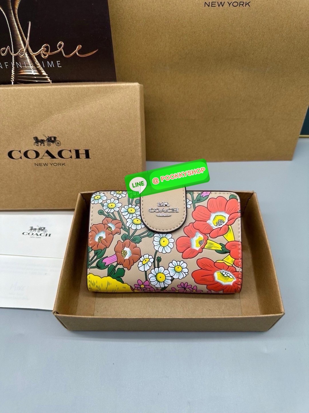 Coach Billfold Wallet With Floral Print Polished pebble leather Eight credit card slots Full-length bill compartment Snap closure Outside zip coin pocket