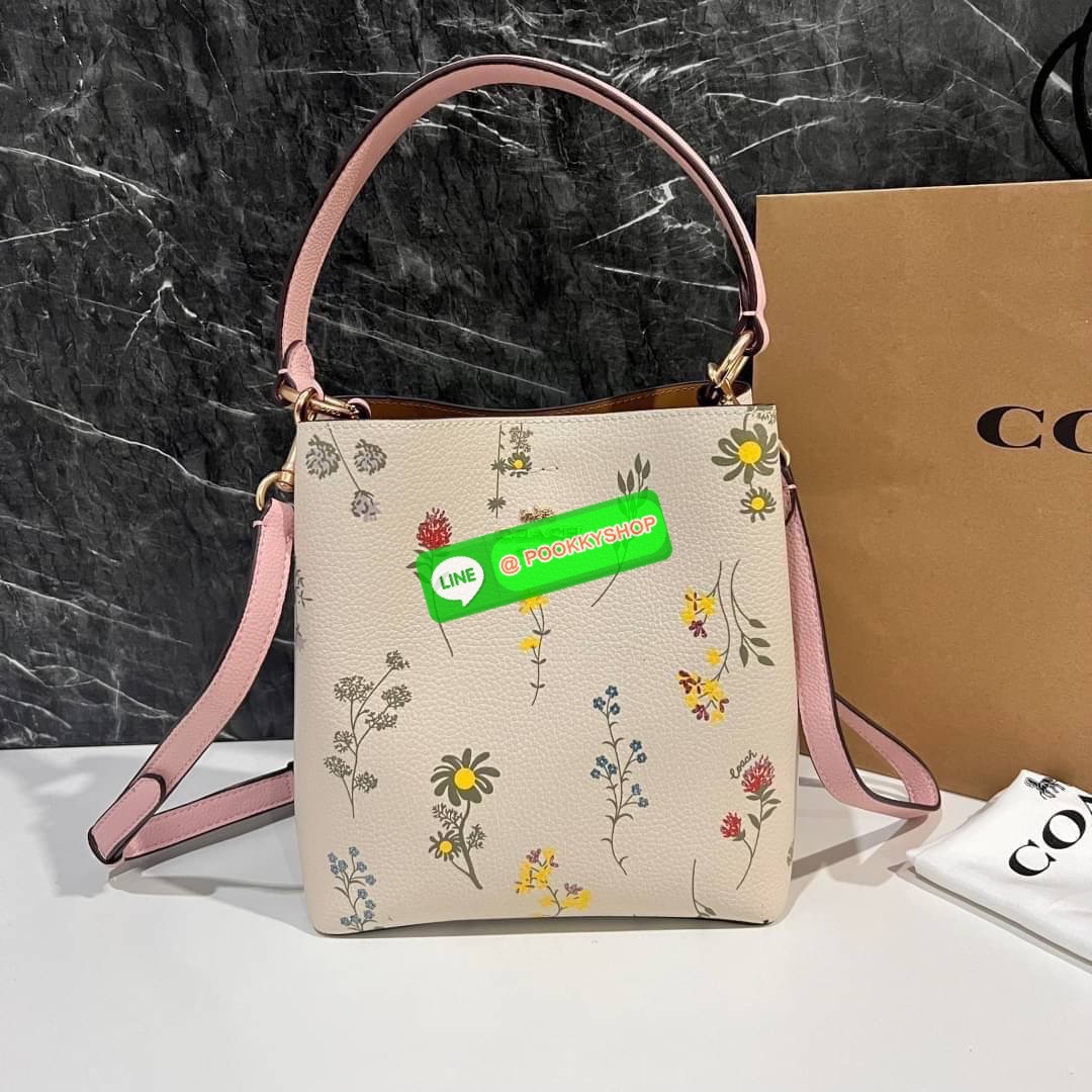 COACH C3598 SMALL TOWN BUCKET WITH SPACED WILDFLOWER PRINT มีความน่ารักละมุนมาก กระเป๋าทรงบัคเก็ต ดีไซน์ดอกไม้คละรอบใบ วัสดุหนังแท้ปากกระเป๋าเปิด-ปิดด้วยกระดุมแม่เหล็ก 2 มีหูจับในตัวและสายสะพายข้าง ภายในโล่งกว้าง มีช่องซิปแยกสัดส่วนตรงกลาง สายสะพายปรับระด