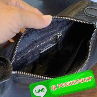 prada nylon shoulder bag black This chic shoulder bag is crafted of fine tessuto nylon in black. This bag features sturdy calfskin leather top handle and silver hardware. The top zipper opens with a black jacquared fabric interior with zipper pocket. This