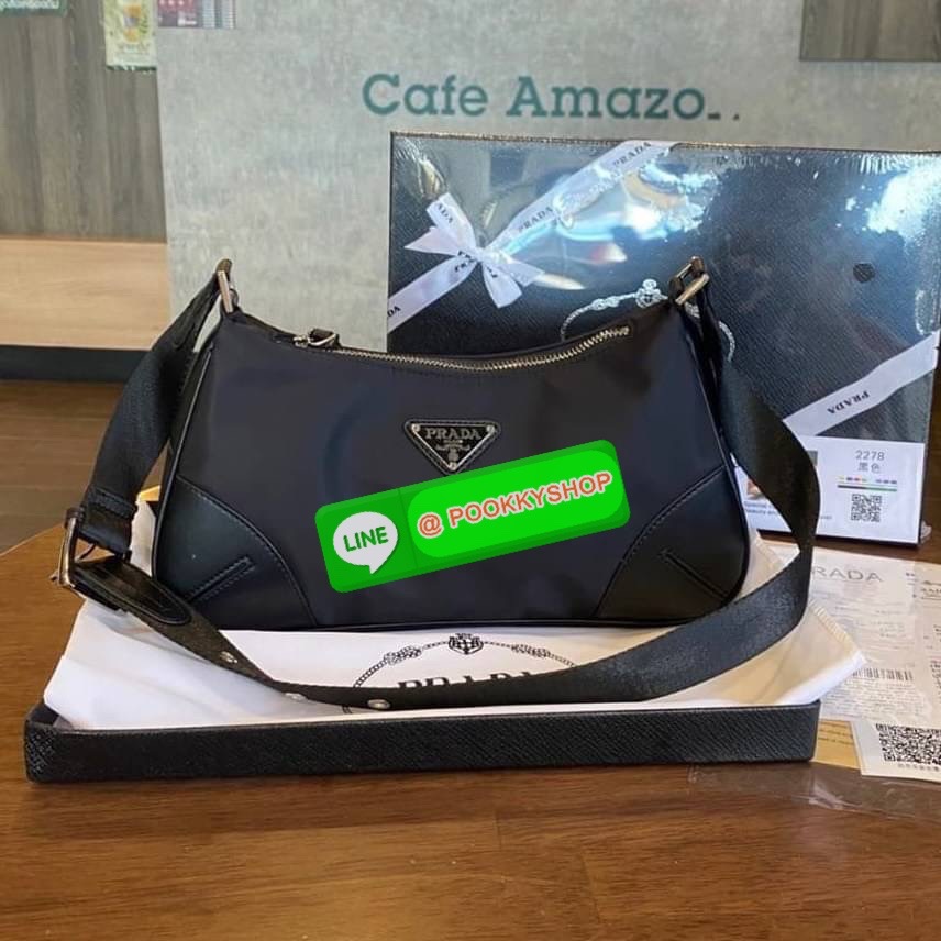 prada nylon shoulder bag black This chic shoulder bag is crafted of fine tessuto nylon in black. This bag features sturdy calfskin leather top handle and silver hardware. The top zipper opens with a black jacquared fabric interior with zipper pocket. This