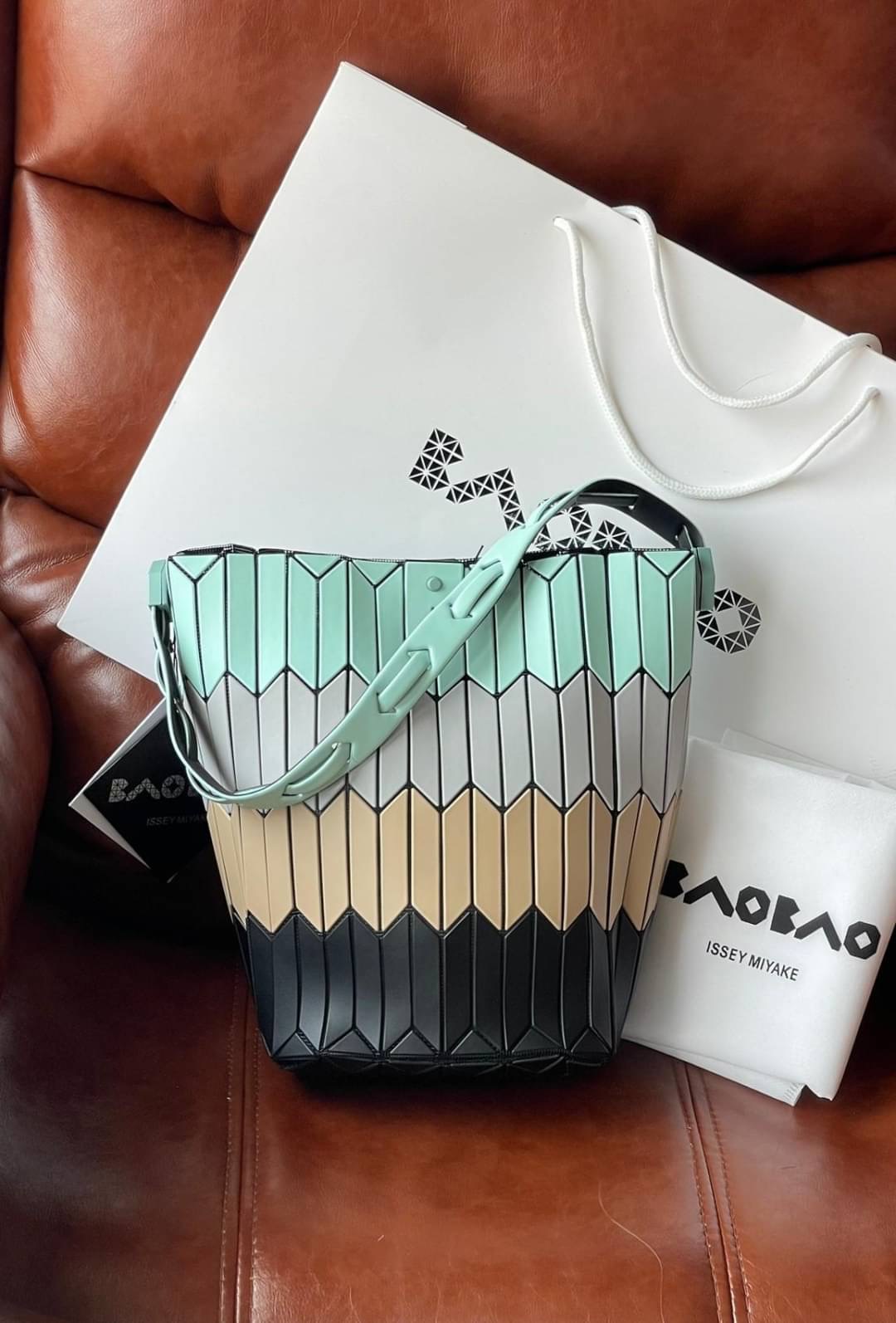 💕Baobao Issey Miyake Large Bucket กระเป๋าบัคเก็ตขนาดใหญ่สามารถใช้ใส่ร่มพับได้หรือขวดน้ำขนาดเล็กได้ ซีรีย์ใหม่นี้มีจุดเด่นที่แผ่นรูปทรงสี่เหลี่ยมด้านขนานในแนวตั้ง เกิดเป็นรูปทรงสามมิติซึ่งแตกต่างไปจากรูปทรงที่เกิดขึ้นจากแผ่นสามเหลี่ยม หูหิ้วสามารถข
