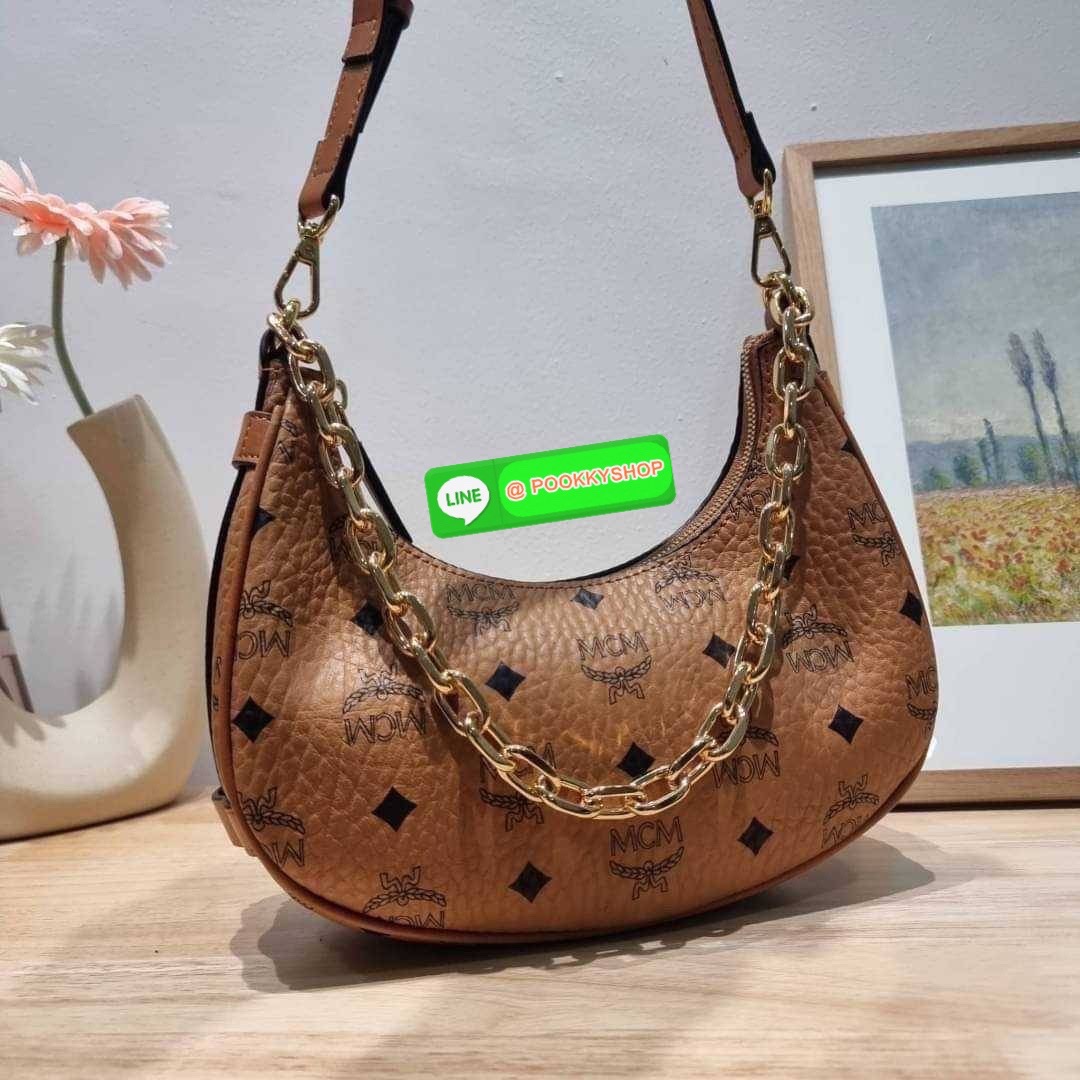 MCM AREN CRESCENT HOBO IN VISETOS ใหม่ล่าสุดก่อนใคร สวยได้ไม่ต้องรอ กับคอลใหม่ลุคลูกคุณ รูปทรง half moon ยอดฮิต ตอบโจทย์ได้ทุกลุค ทุกไลฟ์สไตล์ ใช้งานได้ง่ายคล่องตัว กับกระเป๋าสะพายข้าง ที่มาพร้อมสายโซ่คล้องด้านหน้า และสายหนังครอสบอดี้ ปรับเปลี่ยนการใช้งาน