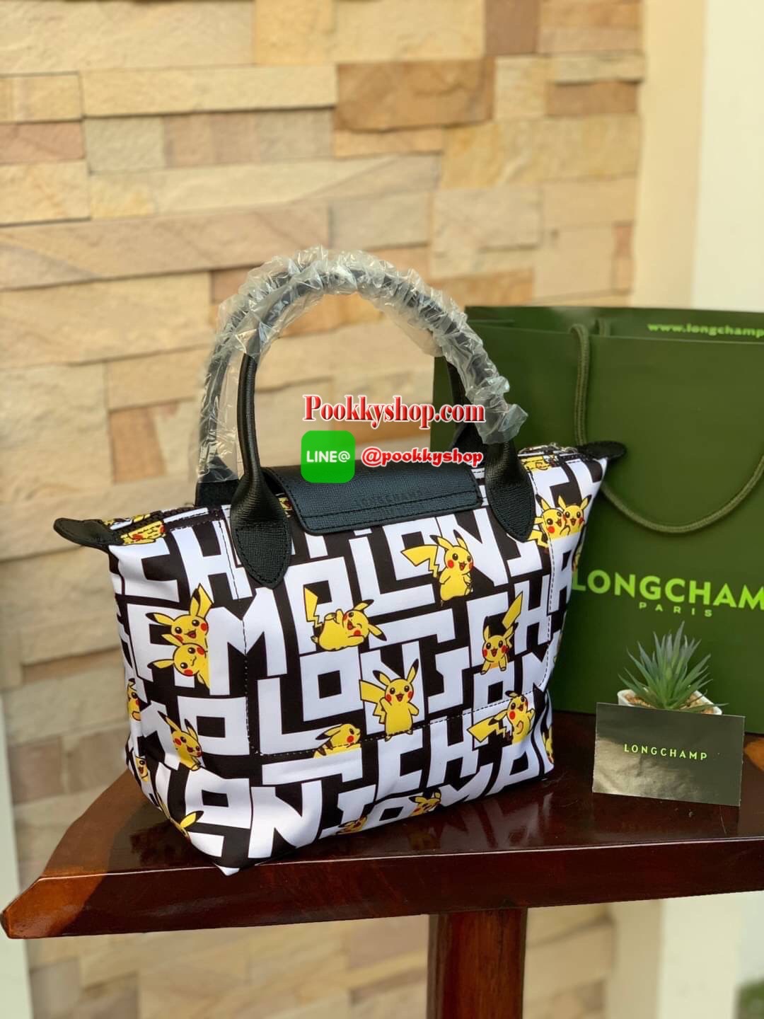 LONGCHAMP X POKÉMON SHOULDER BAG เพราะรู้ว่า &quot;เลอ ปลิยาจ&quot; (Le Pliage) เป็นกระเป๋าไอคอนิคยอดนิยมของคนทุกเพศทุกวัย ไม่ว่าจะเป็นคนธรรมดาหรือเซเล็บ ลองฌอมป์ก็เลยจัดให้ &quot;ปิกาจู&quot; ไปวิ่งเล่นอยู่บนกระเป๋าที่ออกมาเป็นซีรีส์ซะเลย และยังคงความ Le