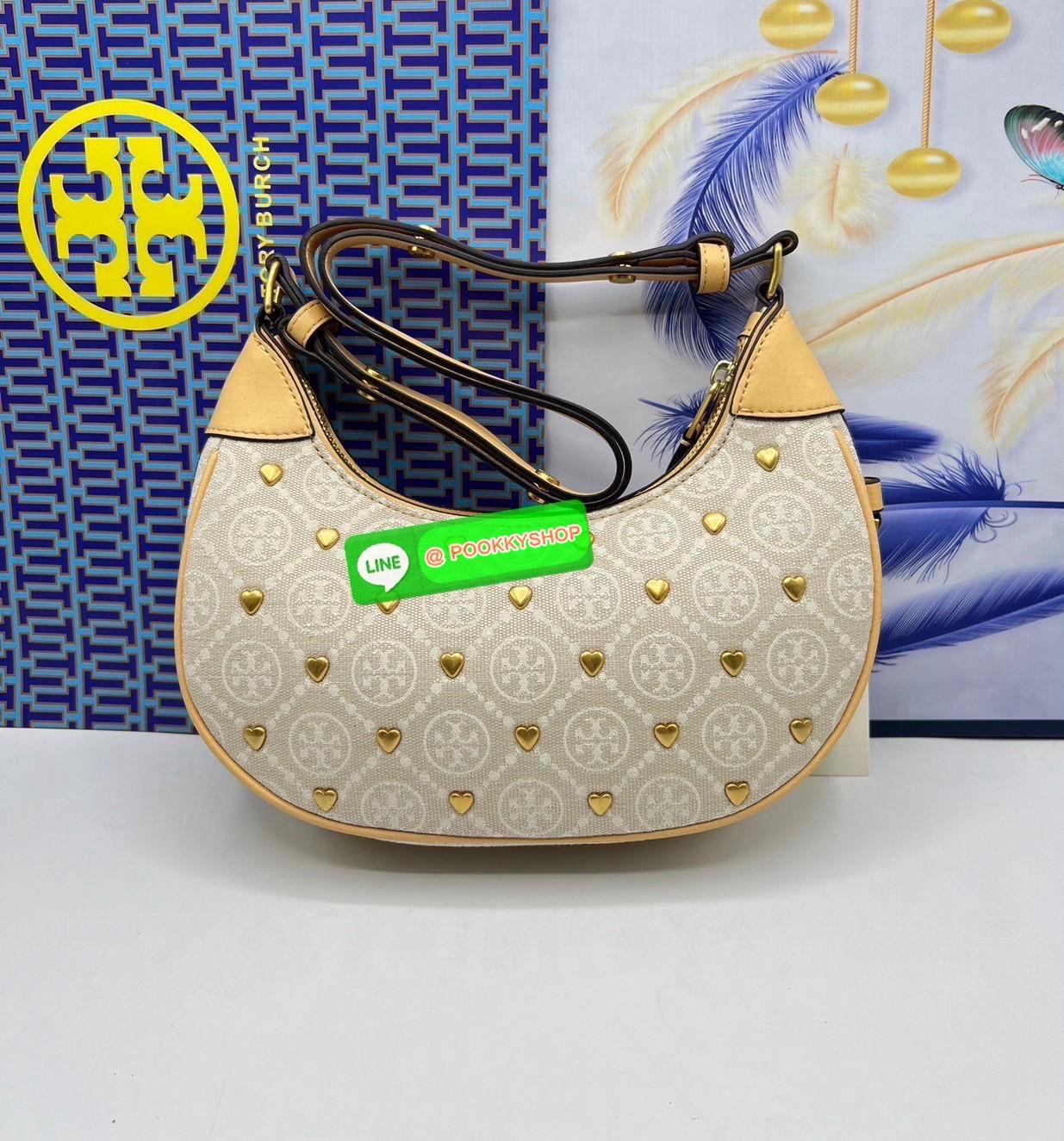 Tory Burch Monogram with Heart Bag คอลเลคชั่นร้อนแรงแห่งปี คอลเลคชั่นทีบ่งบอกสไตล์ที่ทันสมัยทรงครึ่งวงปักลายหัวใจบนกระเป๋าสุดน่ารัก โด่ดเด่น วัสดุผ้าแจคการ์ดตัดหนังแท้ เปิดปิดด้วยซิป
