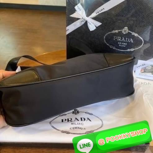 prada nylon shoulder bag black This chic shoulder bag is crafted of fine tessuto nylon in black. This bag features sturdy calfskin leather top handle and silver hardware. The top zipper opens with a black jacquared fabric interior with zipper pocket. This