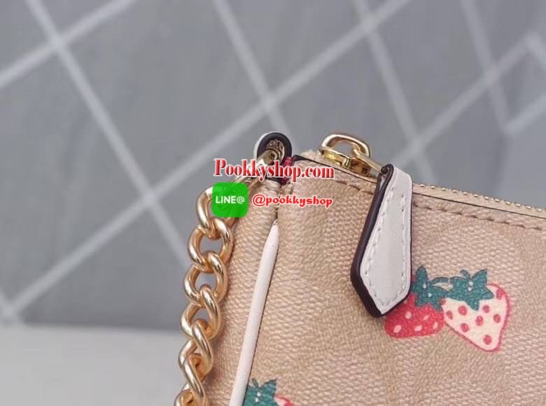 Coach POUCH IN SIGNATURE CANVAS WITH STRAWBERRY Signature coated canvas with smooth leather details Two credit card slots Inside multifunction pocket One zip closure, fabric lining| Detachable strap