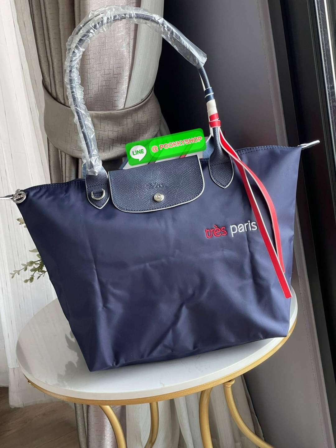 💕LONGCHAMP LE PLIAGE TRES PARIS SHOULDER BAG กระเป๋าโท้ทใบนี้ดึงดูดใจคุณด้วยรูปทรงมินิมอลและปริมาตรที่เพียงพอซึ่งสามารถเก็บเอกสารหรือแล็ปท็อปทั้งหมดของคุณได้อย่างง่ายดาย สายคล้องไหล่มีความยาวช่วยให้คุณสะพายได้อย่างสบาย ขณะที่การปิดด้วยซิปช่วยให้มั