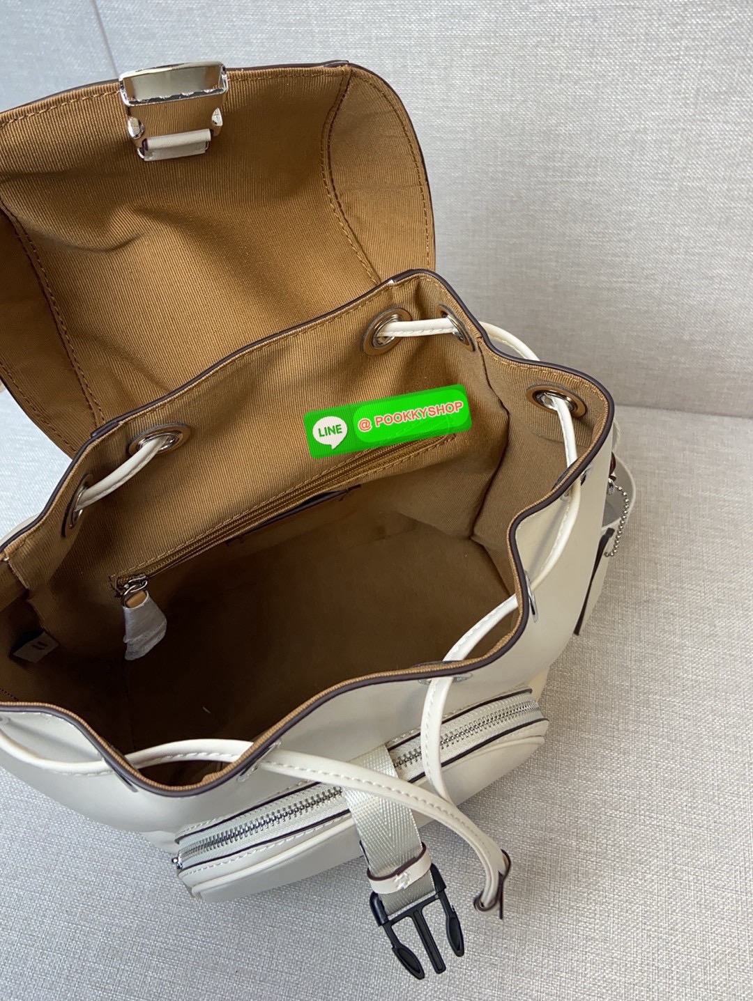 COACH PACE BACKPACK COACH CR100 | Refined calf leather | Inside zip and multifunction pockets | Drawstring and speedclip closures, fabric lining | Handle with 3" drop | Outside zip pocket | Outside zip access to interior |