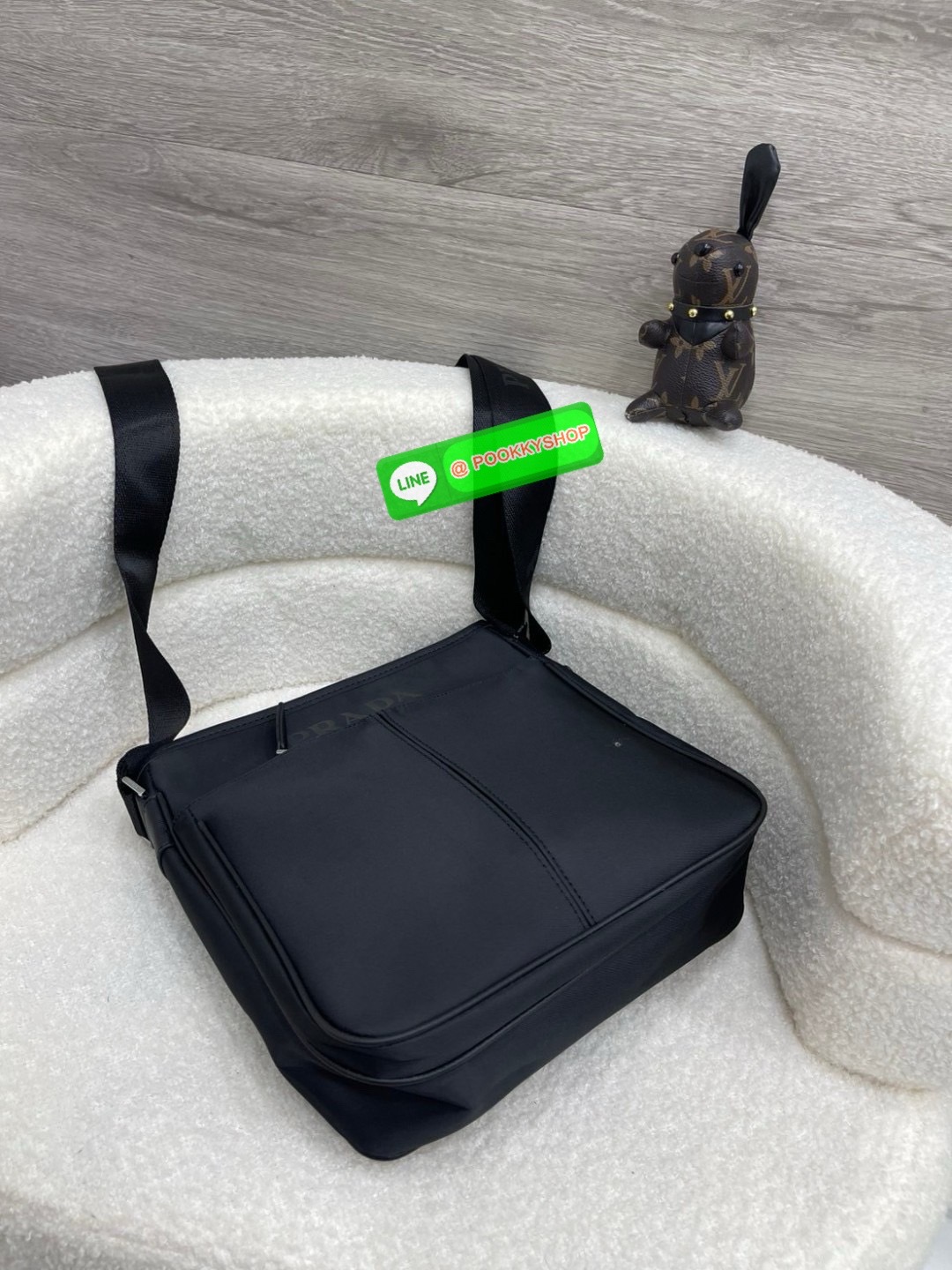 Prada Re-Nylon and Saffiano leather shoulder bag Size 11” Adjustable woven nylon tape and leather shoulder strap with removable pouch Enameled metal triangle logo on the front Zipper closure External zipper pocket Internal patch pocket Re-Nylon logo-print