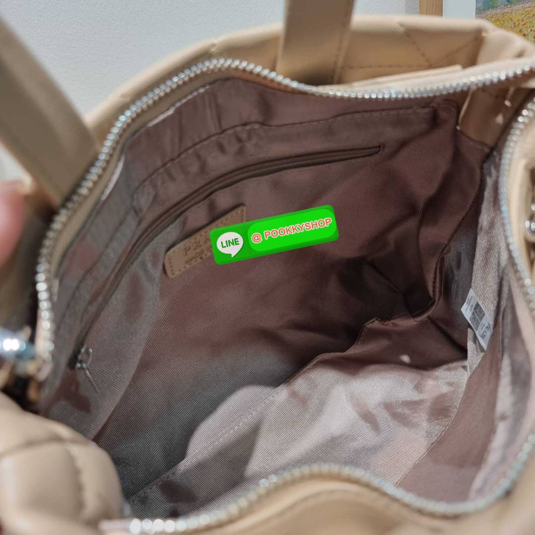 PRADA LEATHER PADDED BAG ใหม่ล่าสุด กับคอลเลคชั่นที่ทำออกมาตอบโจทย์ได้ทุกไลฟ์สไตล์ และเป็นยูนิเซ็กส์ กับกระเป๋าทรงโท้ท ขนาดกำลังดี วัสดุหนังแท้ ตัดเย็บเดินเส้นลายตาราง ปากกระเป๋ามีซิปเปิดปิด ภายในเป็นช่องโล่ง มีช่องแยกให้ มาพร้อมสะพายข้างและใบลูก ให้ได้สน