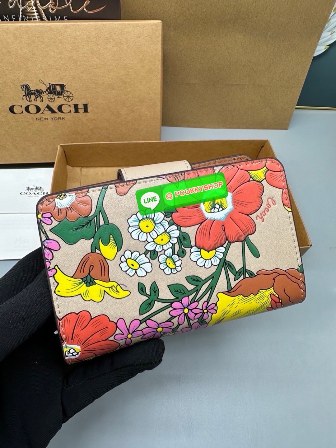 Coach Billfold Wallet With Floral Print Polished pebble leather Eight credit card slots Full-length bill compartment Snap closure Outside zip coin pocket
