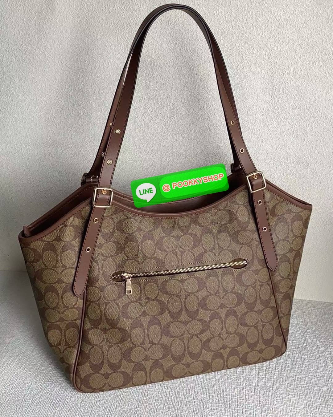 รุ่น: Coach CM076 – Gallery Tote In Signature Canvas • รายละเอียด: กระเป๋าทรง Tote รุ่น Gallery ลาย Signature Canvas คลาสสิก ตัดขอบหนังแท้สีดำเข้ม สายสะพายคู่ปรับระดับได้ ภายในกว้าง ใส่ของทำงานหรือเรียนได้สบาย มีช่องซิปหลัก 1 ช่อง และช่องเสริมด้านในอีกหลา